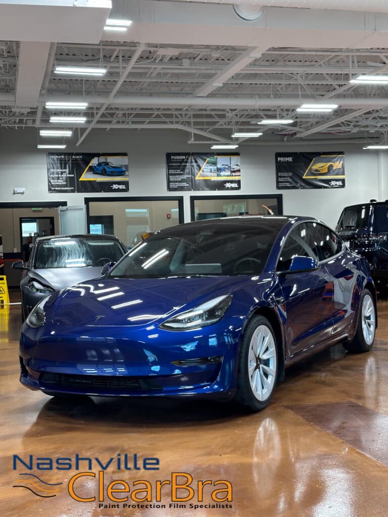 Tesla Model 3 Blue Xpel Paint Protection Film. Tesla Model 3 owners, especially those in Brentwood and Franklin, Tennessee, understand the importance of protecting their investment. With the increasing number of Teslas on the road, maintaining the pristine condition of your vehicle is more crucial than ever. At Nashville ClearBra, we specialize in applying XPEL Paint Protection Film (PPF) to ensure your Tesla Model 3 in Blue remains flawless. This blog post delves into the benefits of XPEL PPF, the services we offer, and why choosing Nashville ClearBra is the best decision for your Tesla Model 3.