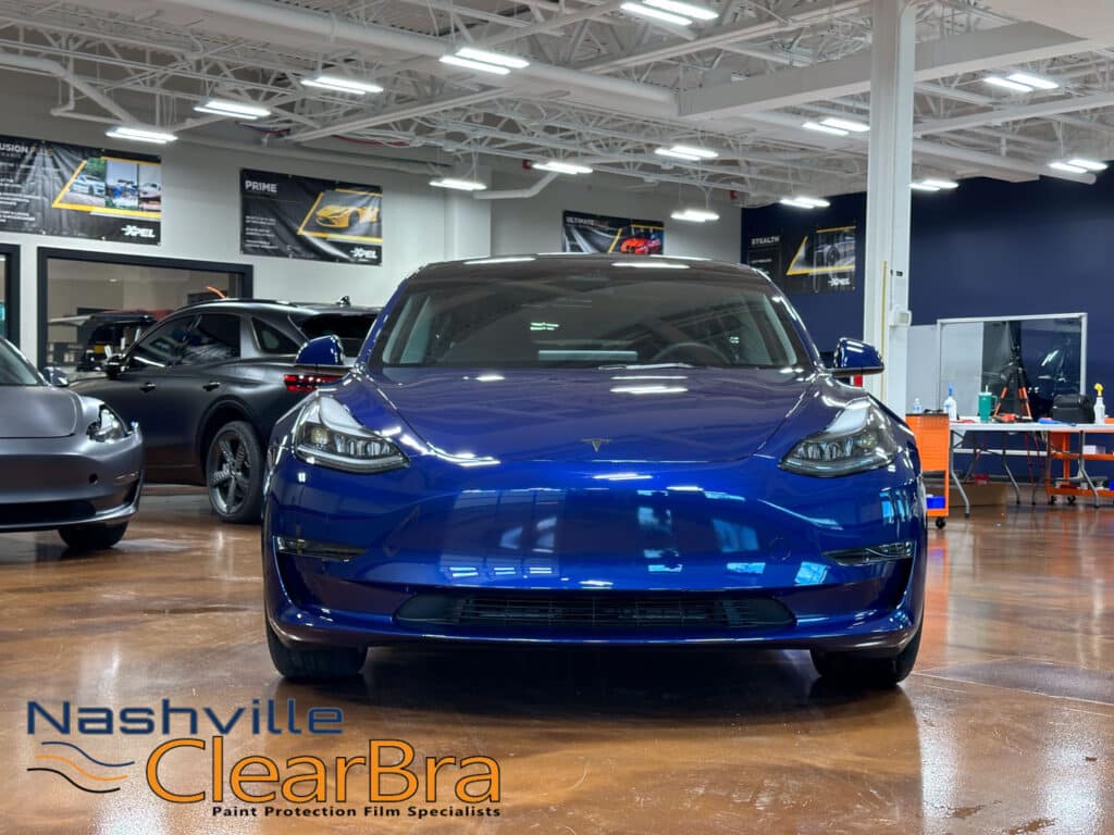 Tesla Model 3 Blue Xpel Paint Protection Film. Tesla Model 3 owners, especially those in Brentwood and Franklin, Tennessee, understand the importance of protecting their investment. With the increasing number of Teslas on the road, maintaining the pristine condition of your vehicle is more crucial than ever. At Nashville ClearBra, we specialize in applying XPEL Paint Protection Film (PPF) to ensure your Tesla Model 3 in Blue remains flawless. This blog post delves into the benefits of XPEL PPF, the services we offer, and why choosing Nashville ClearBra is the best decision for your Tesla Model 3.